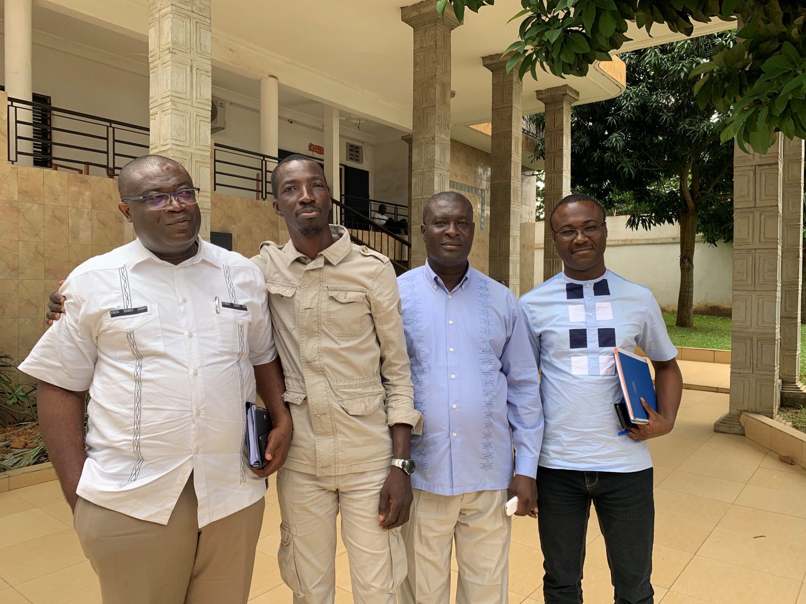 Four men standing outside