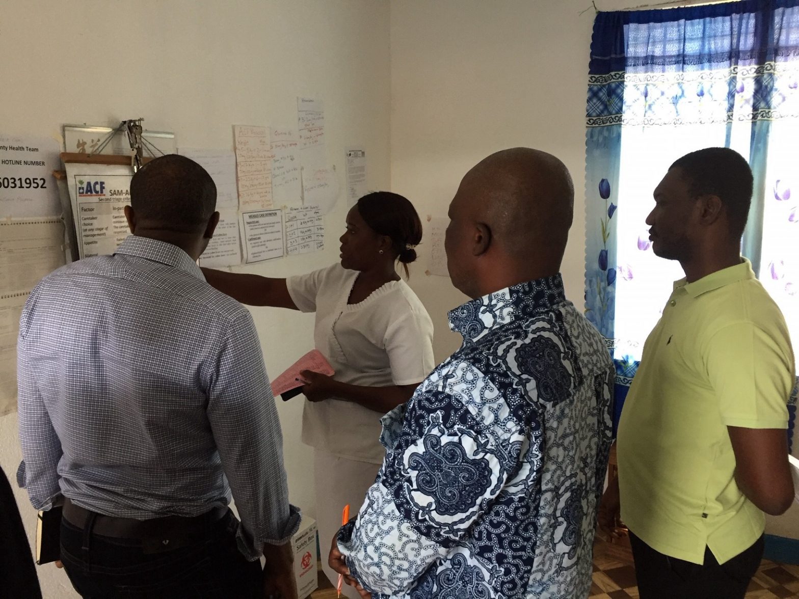 Representatives from Health Strategy Delivery Foundation, Accelerator and USAID/Liberia receive a tour of a primary facility.
