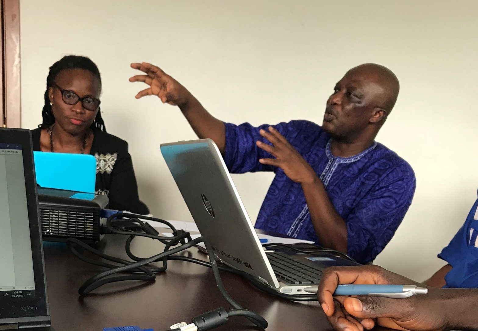 A man provides guidance to Ministry of Health officials in making decisions