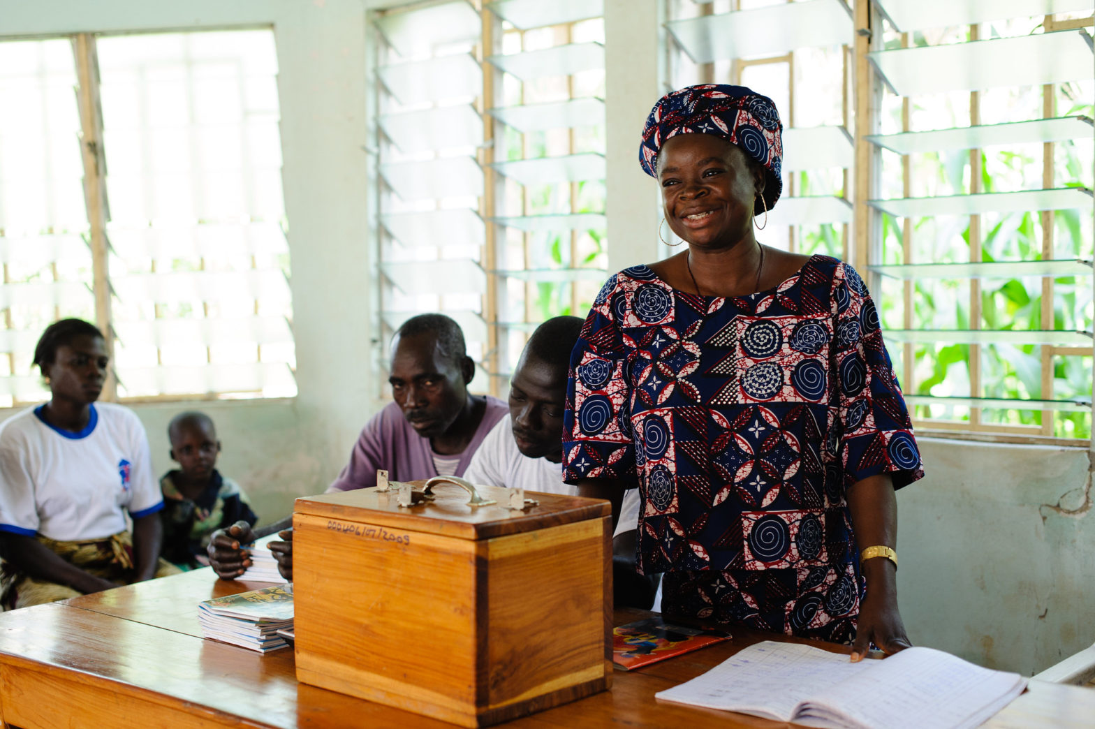 A participant at a savings group meeting at the Hope Through Health clinic in Kara, Togo on 5 August 2013. Photo credit: Dining for Women/Hope Through Health in Togo