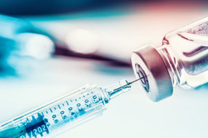 Close-up image of a syringe and drug vial